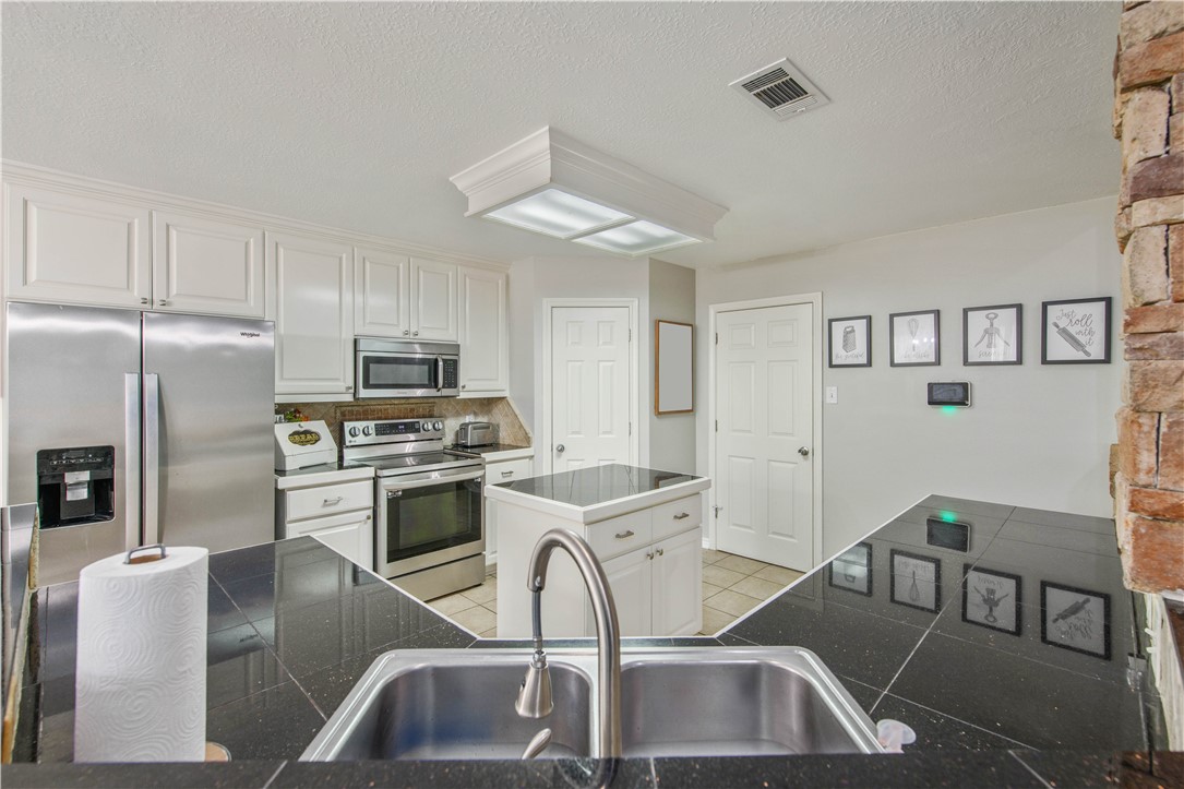 6538 Olympia Buddy Road College Station, TX 77845 - Photo 17 of 50 a kitchen that has a cabinets counter space and stainless steel appliances
