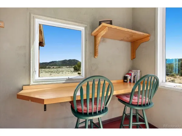 a view of a room with furniture and a window