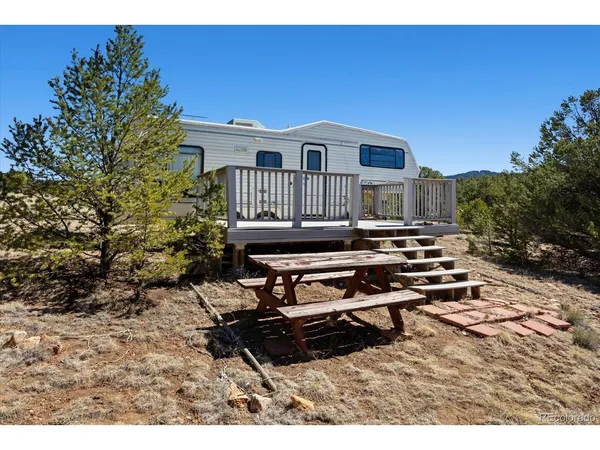 a view of balcony with wooden floor and fence