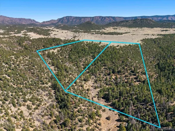 a view of mountain with sunset in background