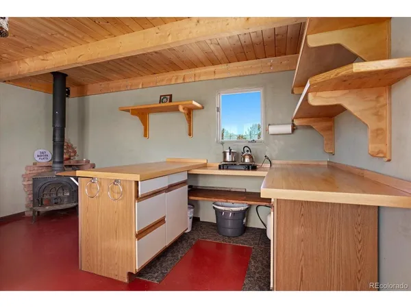 a utility room with cabinets and a wooden floor