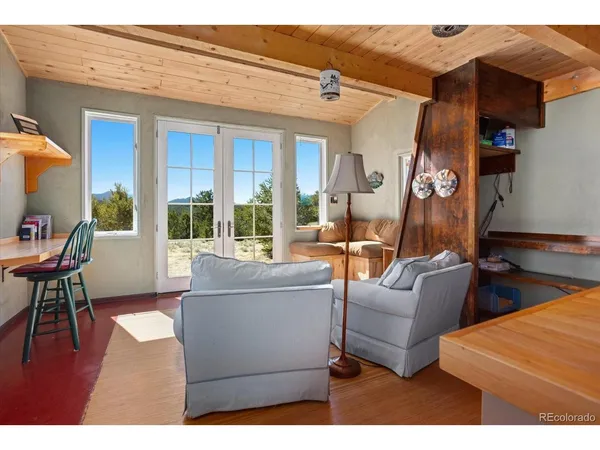 a living room with furniture and a floor to ceiling window