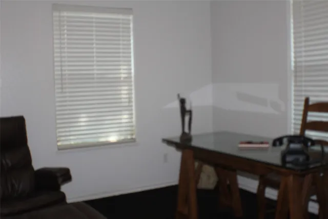 a bathroom with a granite countertop toilet and a sink