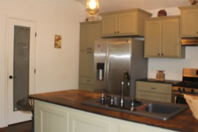 a kitchen with a refrigerator and cabinets