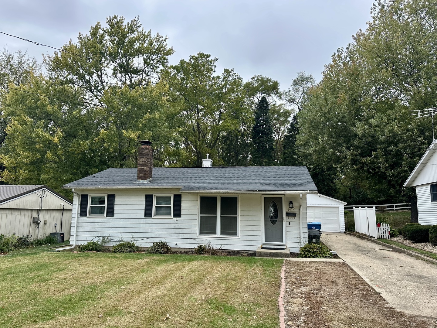 925 Assembly Place Dixon, IL 61021 - Photo 1 of 19 a front view of a house with a garden and trees