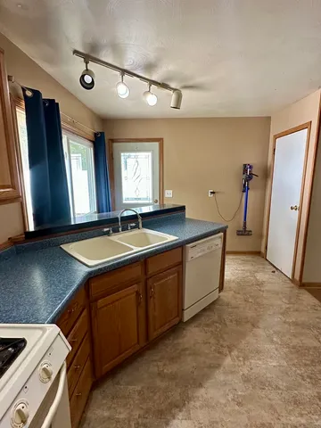 a room with a sink and a refrigerator