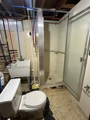 a bathroom with a granite countertop toilet sink and shower