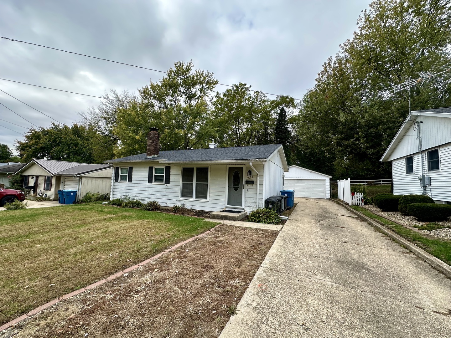 925 Assembly Place Dixon, IL 61021 - Photo 2 of 19 a front view of a house with a garden and trees