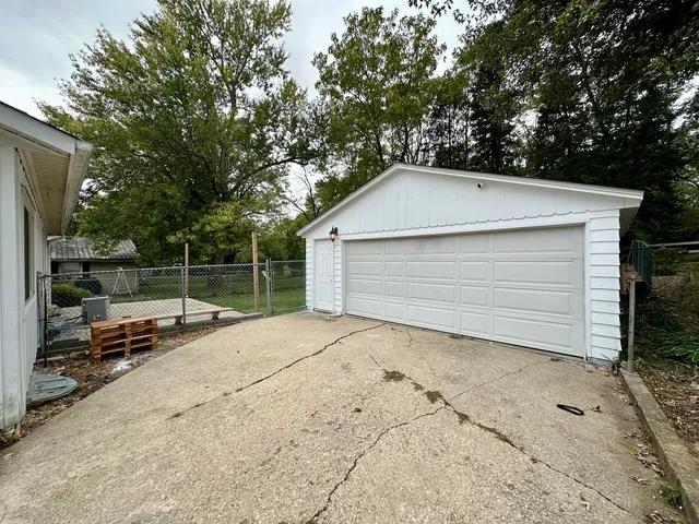 a view of backyard of house and car parked