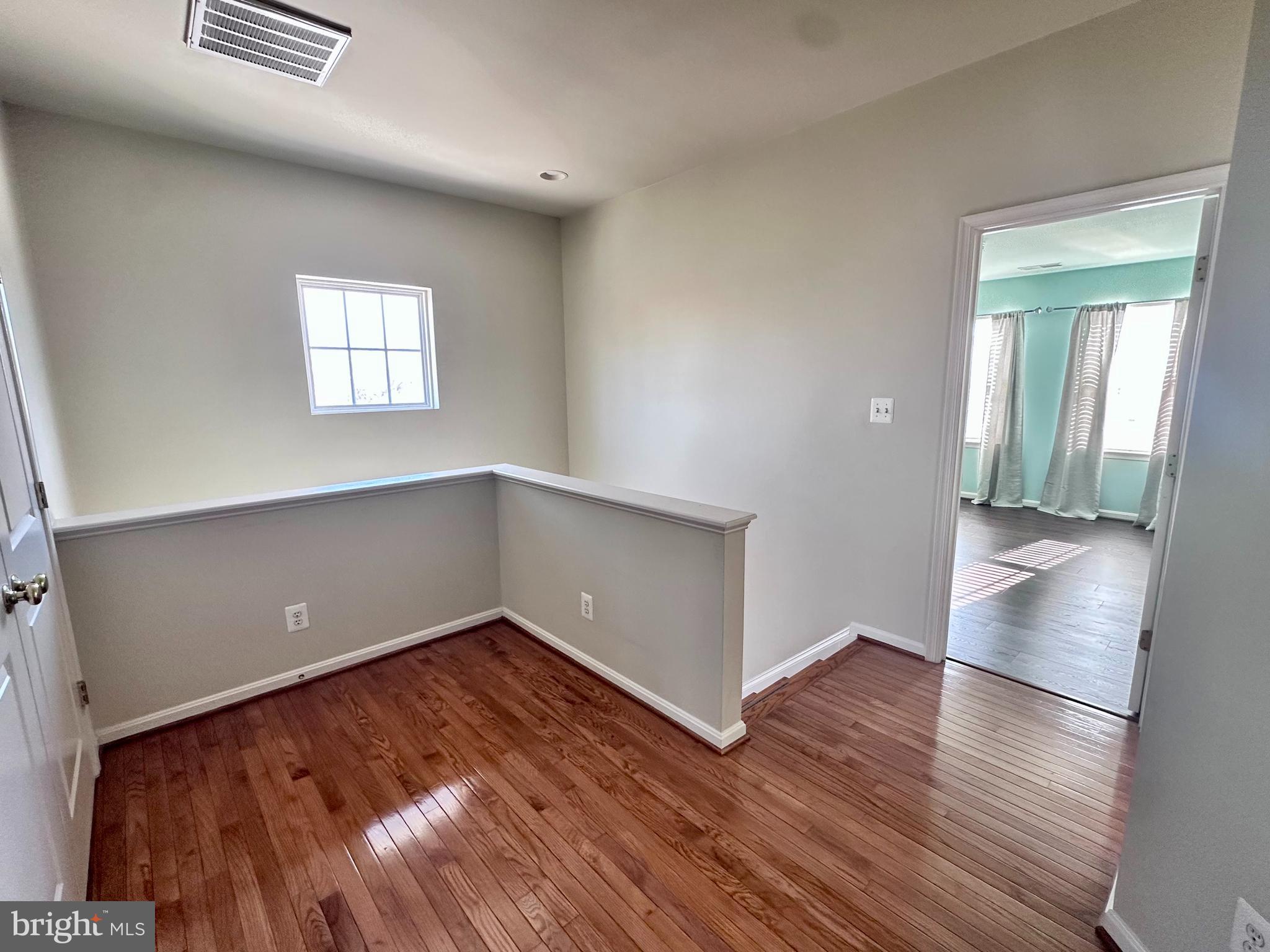 43270 Sunderleigh Square Broadlands, VA 20148 - Photo 13 of 24 an empty room with wooden floor and windows