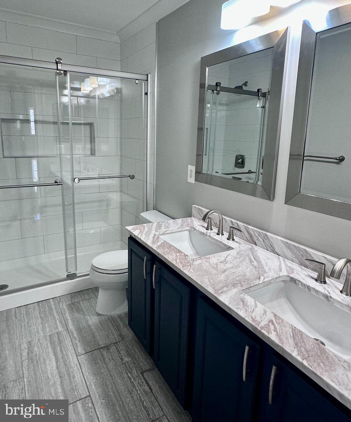 43270 Sunderleigh Square Broadlands, VA 20148 - Photo 16 of 24 a bathroom with a granite countertop sink toilet and shower