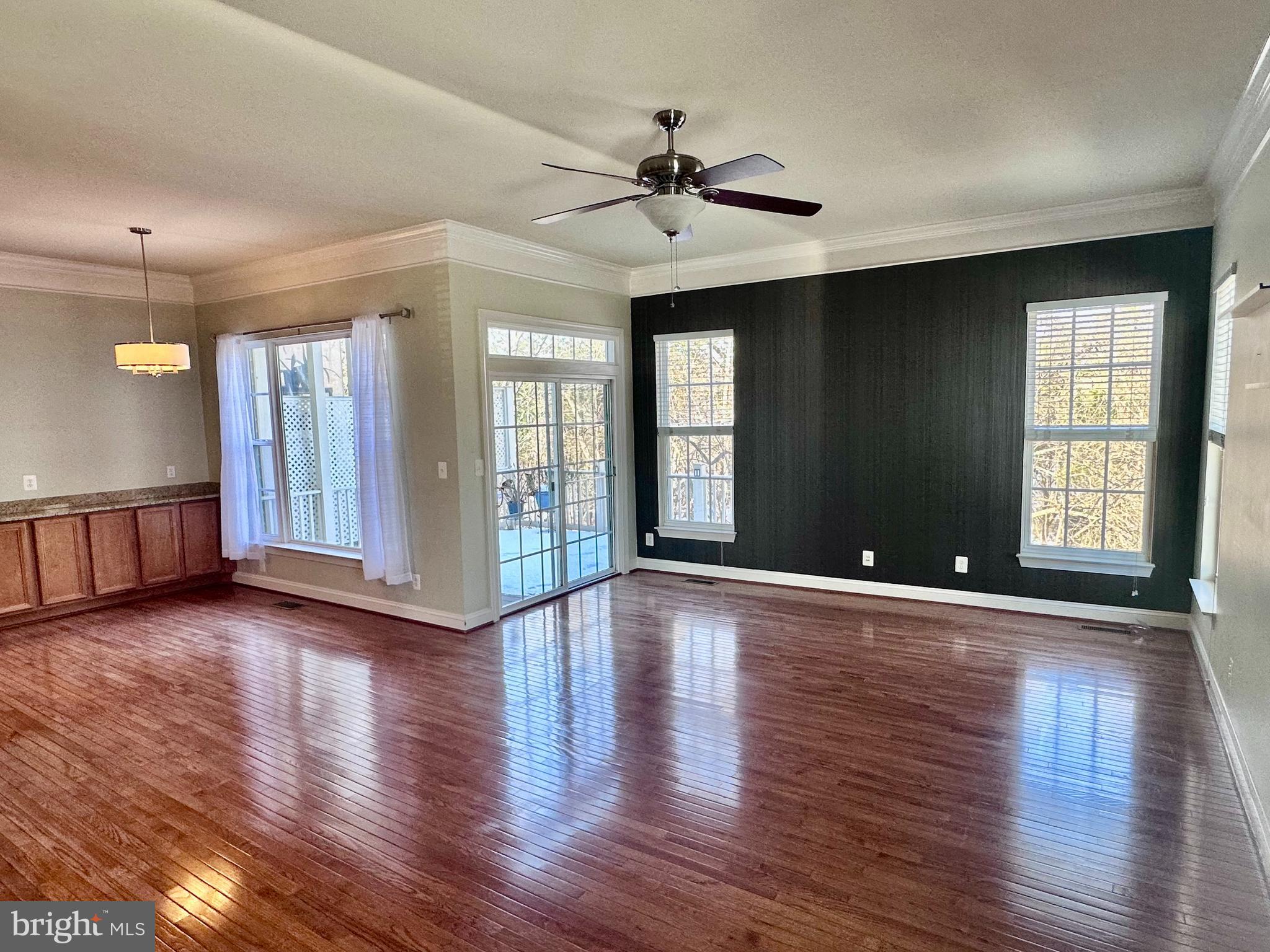 43270 Sunderleigh Square Broadlands, VA 20148 - Photo 4 of 24 a view of an empty room with window and wooden floor