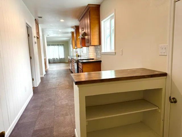 a hallway with a sink and a mirror