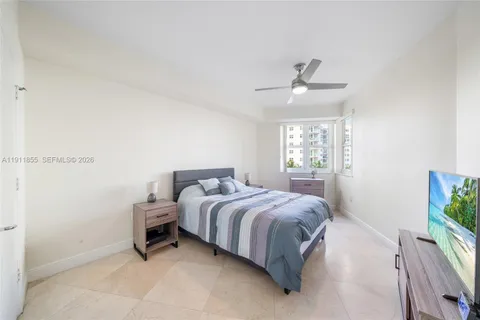 a spacious bedroom with a bed and a window