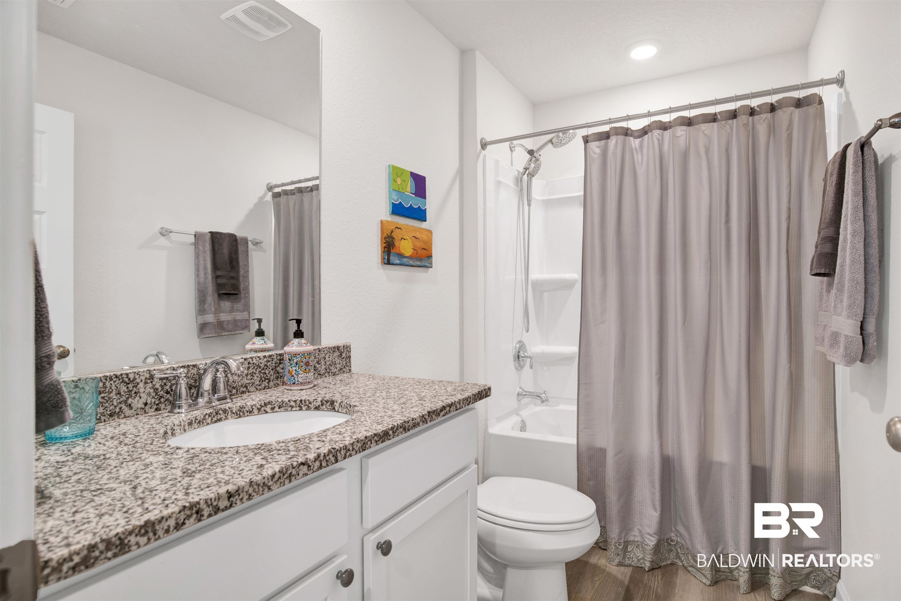 22348 Aleutian Avenue Foley, AL 36535 - Photo 20 of 32 Full bathroom with vanity, light wood-style flooring, and shower / tub combo with curtain