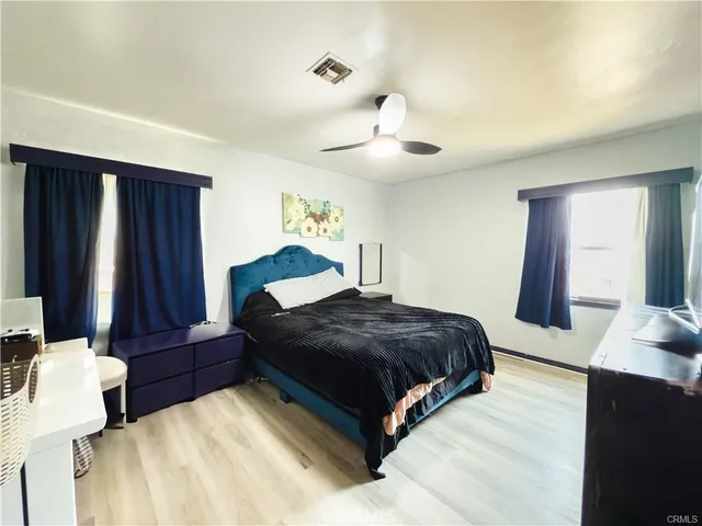 a bedroom with a bed window and dresser