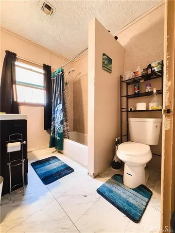 a bathroom with a toilet a sink and a mirror