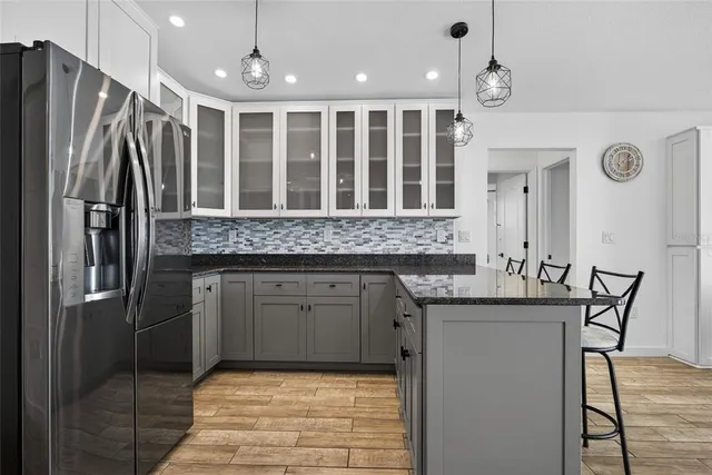 a kitchen with stainless steel appliances granite countertop a refrigerator and a sink