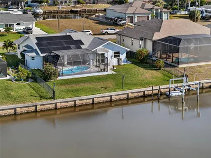an aerial view of a house with a garden and pool
