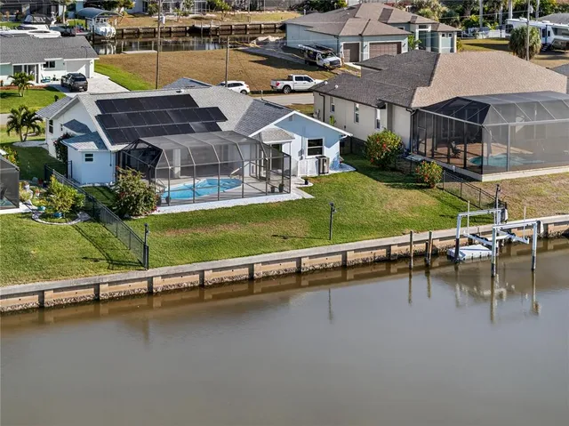an aerial view of a house with a garden and pool