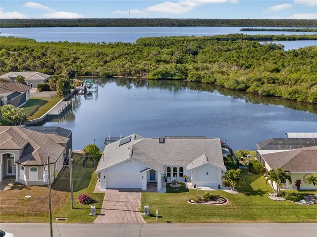 an aerial view of a house with a lake view