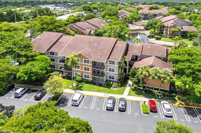 an aerial view of multiple houses with yard