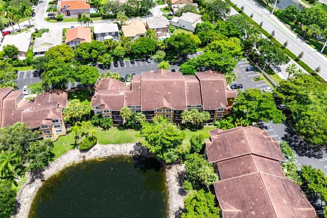 an aerial view of a house with garden space and street view
