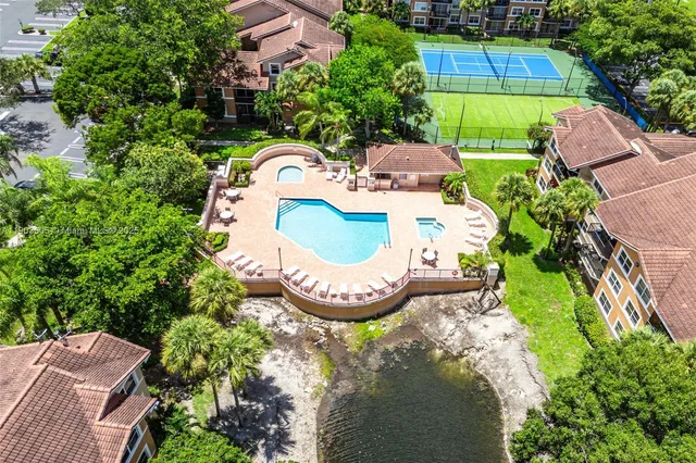 an aerial view of a house with a yard