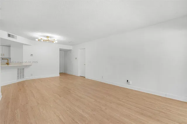 a view of a kitchen with an empty space and a sink