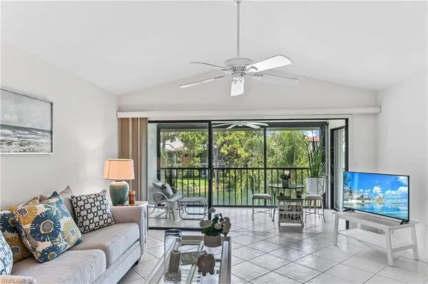 a living room with furniture and a floor to ceiling window