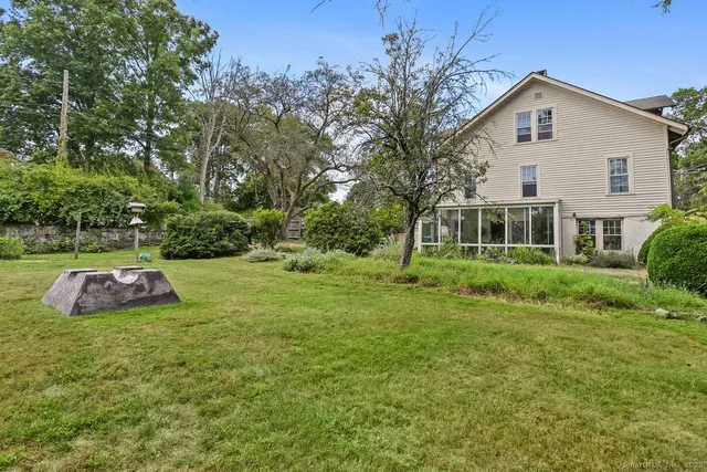 a front view of a house with yard and green space