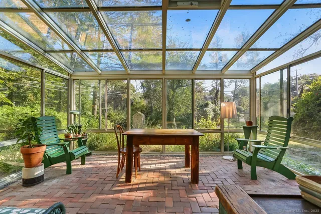 a living room filled with furniture and a potted plant