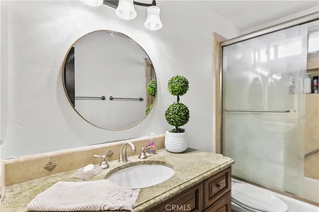 a bathroom with a sink mirror and toilet