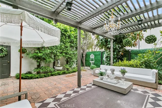 a view of a patio with table and chairs and potted plants