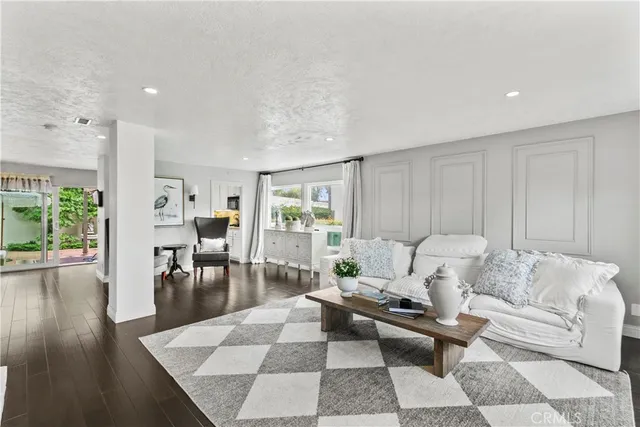 a living room with furniture wooden floor and a table