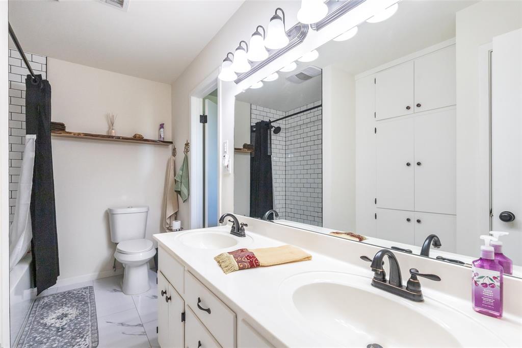 642 Fm 3200 Comanche, TX 76442 - Photo 20 of 37 a bathroom with a sink and mirror with toilet
