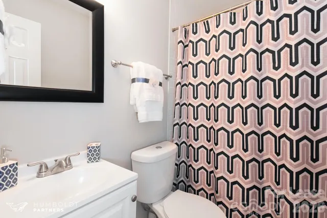a white toilet sitting next to a bathroom sink