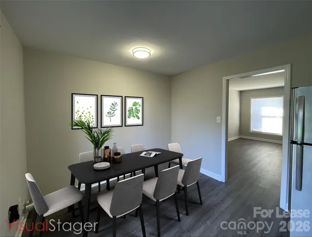a view of a dining room with furniture and a potted plant