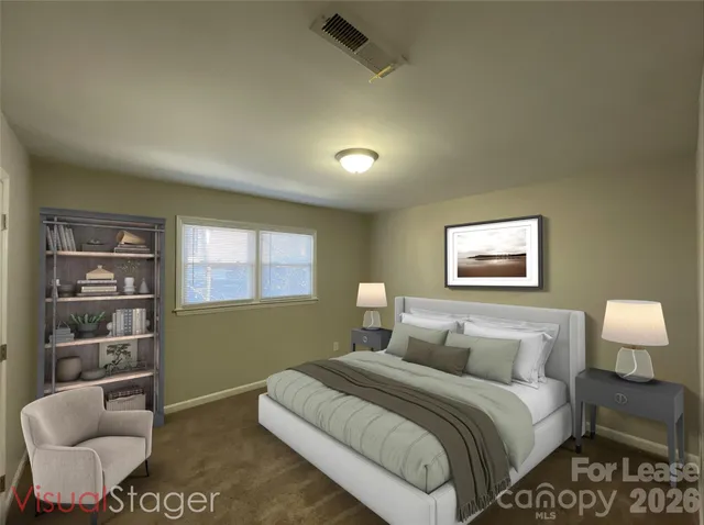 a bedroom with bed and a couch