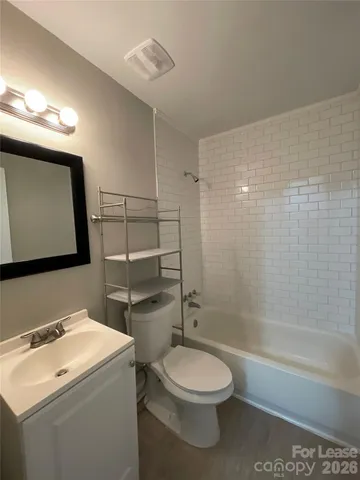 a bathroom with a toilet sink and shower