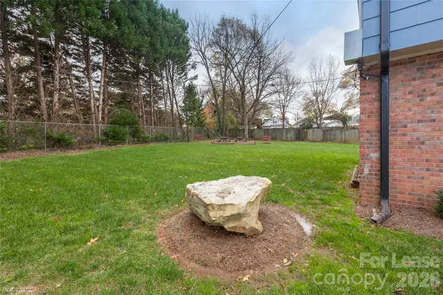 a view of a backyard with chair and garden