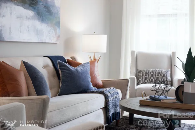 a living room with furniture and a lamp