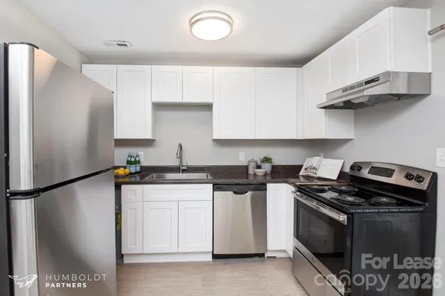 a kitchen with stainless steel appliances and white cabinets