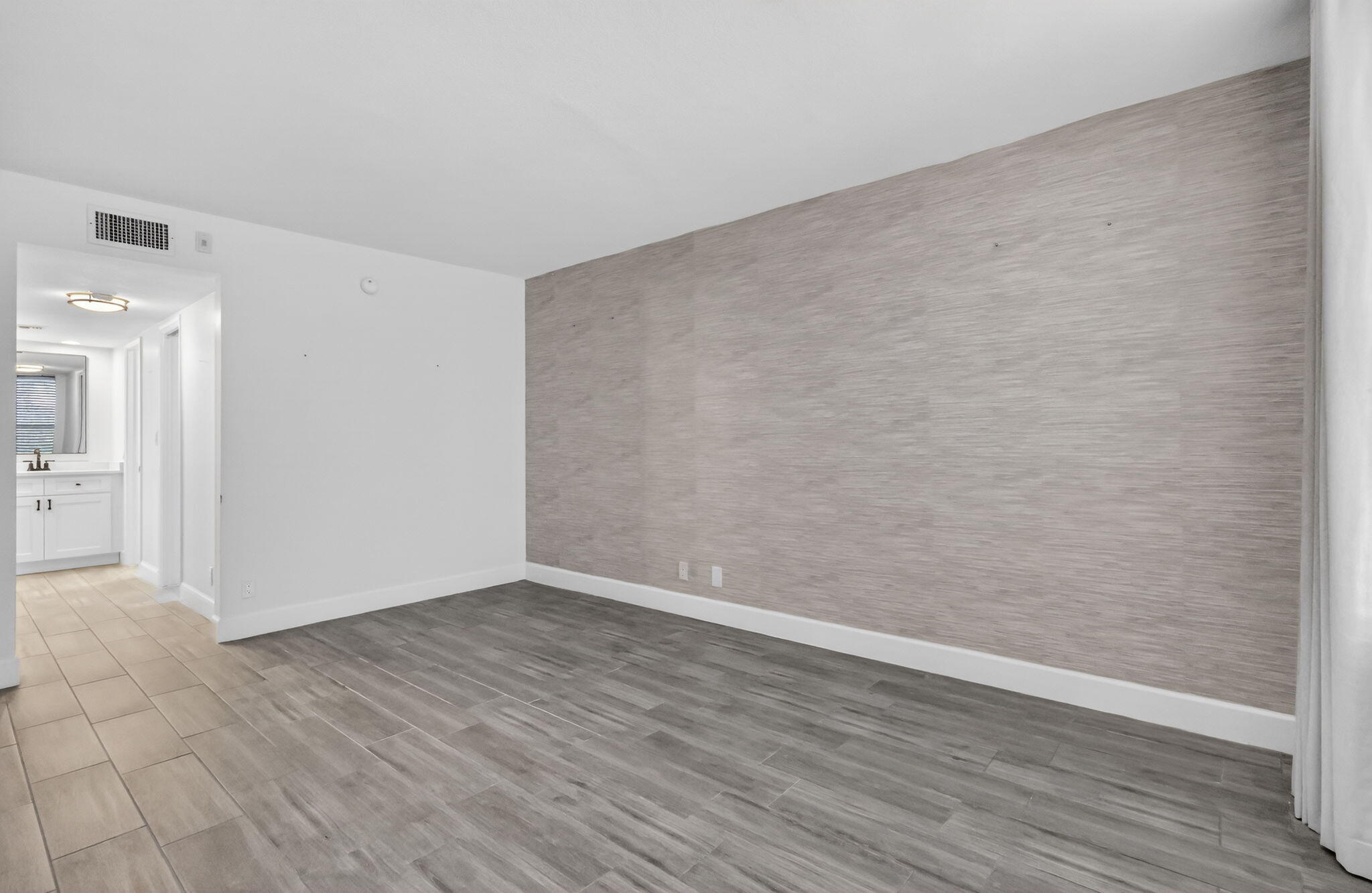 545 Oaks Lane, Unit 409 Pompano Beach, FL 33069 - Photo 12 of 25 a view of an empty room with wooden floor