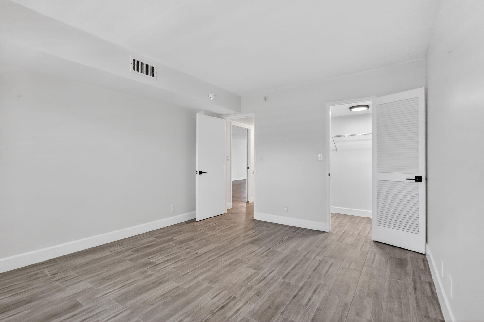 545 Oaks Lane, Unit 409 Pompano Beach, FL 33069 - Photo 17 of 25 wooden floor in an empty room