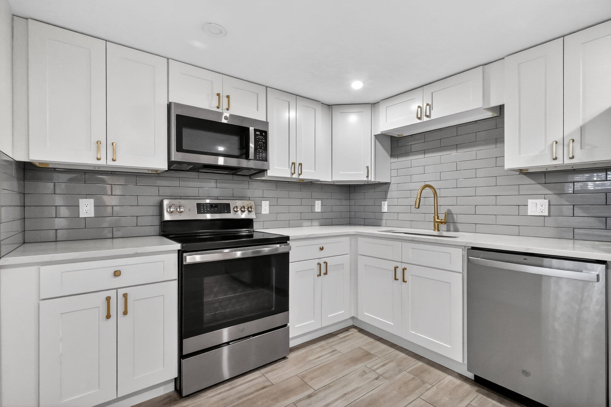 545 Oaks Lane, Unit 409 Pompano Beach, FL 33069 - Photo 4 of 25 a kitchen with stainless steel appliances granite countertop a sink a stove a microwave and cabinets