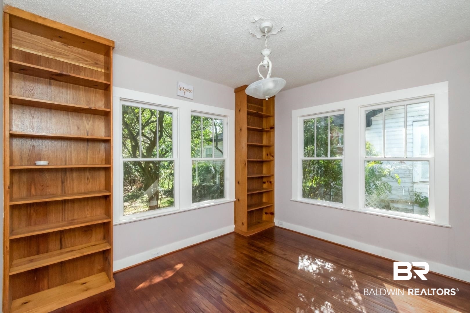 731 Jemison Street Mobile, AL 36606 - Photo 13 of 27 Empty room with a textured ceiling and dark wood finished floors