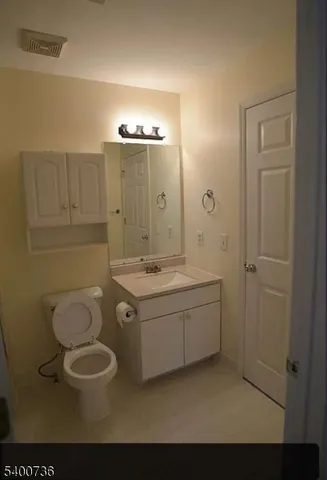 a spacious bathroom with a granite countertop sink a toilet and shower