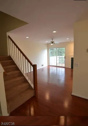 a view of an entryway with wooden floor