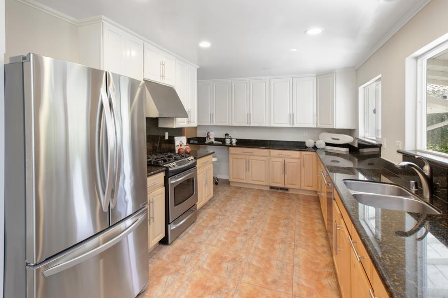 1055 Cascade Drive Menlo Park, CA 94025 - Photo 11 of 24 a kitchen with granite countertop a refrigerator stove and sink